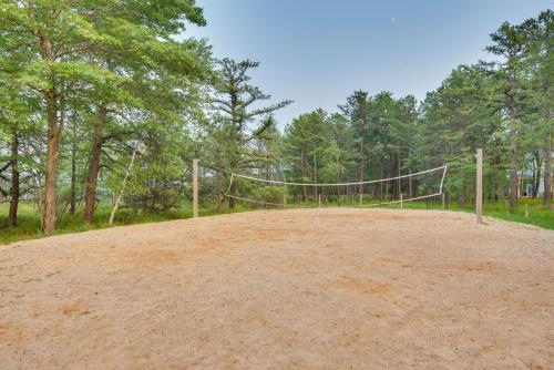 a volleyball net in the middle of a dirt field at Serene Poconos Cabin with Hot Tub and Beach Access! in Albrightsville