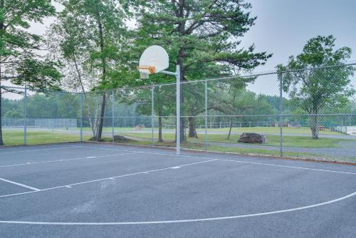 a basketball hoop on a tennis court at Serene Poconos Cabin with Hot Tub and Beach Access! in Albrightsville