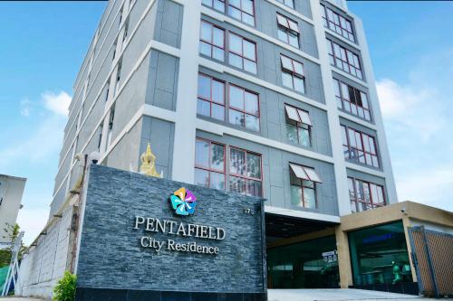 a building with a sign in front of it at PENTAFIELD CITY RESIDENCE in Amphoe Phra Khanong
