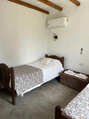 a bedroom with two beds and a air conditioner at El Garzal in Mercedes