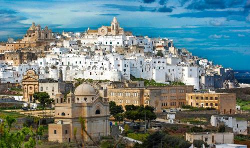 a group of white buildings on top of a hill at UNICO Albatres Palace Salento by Life Resorts in San Vito dei Normanni