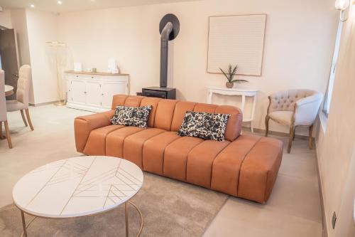a living room with a couch and a table at Château du Parc - Gîtes & spas à Pézenas in Pézenas