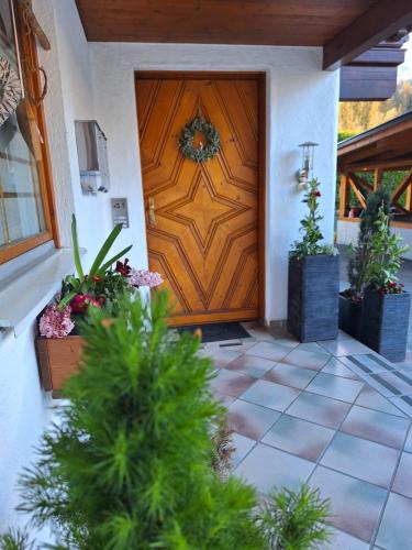 a wooden door of a house with potted plants at Haus Rieder in Pfarrwerfen
