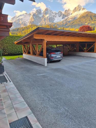 a car parked in a garage with mountains in the background at Haus Rieder in Pfarrwerfen