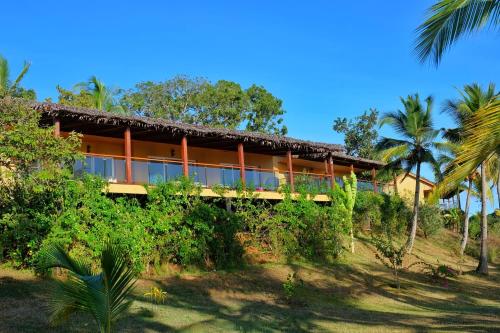 a house on a hill with palm trees at Belamandy Lodge in Anjramarango