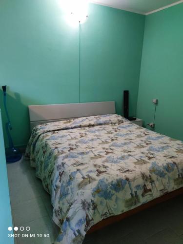 a bedroom with a bed with a bedspread on it at Swimming and Sun in Gandosso