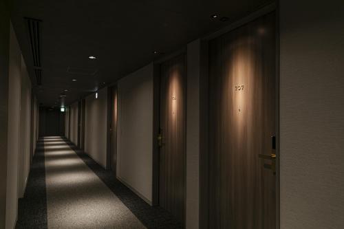 a hallway with a row of elevators in a building at Shimanami PRIME HOTEL IMABARI in Imabari