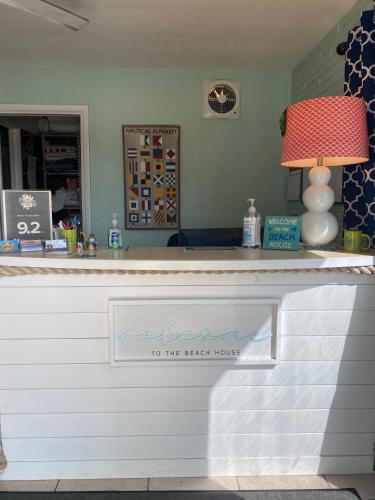 a bar with a sign that says welcome to the highest house at The Beach House - Treasure Island in St Pete Beach