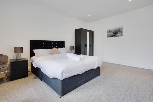 sypialnia z dużym łóżkiem z białą pościelą w obiekcie Wimbourne Road Apartment 3 w Bournemouth