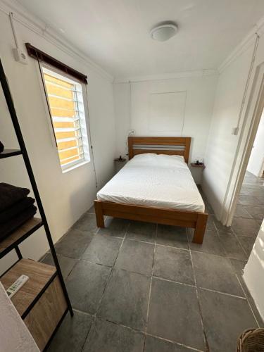 a bedroom with a bed in a room with a window at Casita de Rincon 1 in Hato
