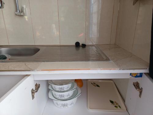 a kitchen with a sink and some dishes at Kioka gardens - stand alone with wifi and parking in Nanyuki
