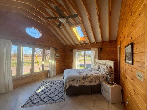 a bedroom with a bed and a ceiling fan at Light House in Brackley Beach