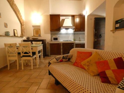 a living room with a couch and a dining room at SCAPPO IN UMBRIA, nel vicolo in Amelia
