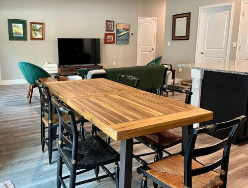 a dining room with a wooden table and chairs at Sweet Stay with fully fenced yard in Sanford