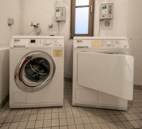 two machines and a washing machine in a bathroom at Apartment 16 - Ferienresidenz Roseneck, Galeriewohnung, mit Schwimmbad in Todtnauberg bei Feldberg in Todtnauberg