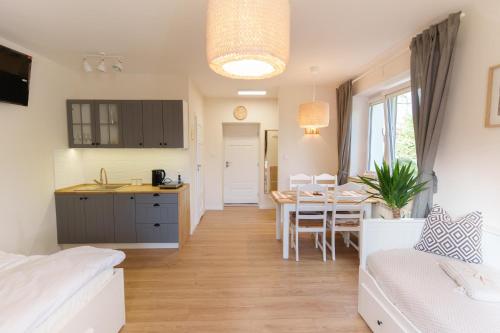 a kitchen and living room with a table and a dining room at Słone 103 in Kudowa-Zdrój
