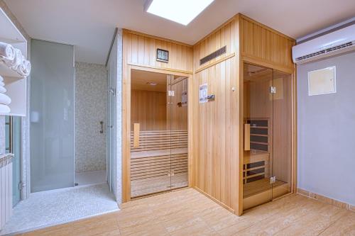 a closet with wooden cabinets and a glass door at Boutique Hotel Santa Maria in Novigrad Istria