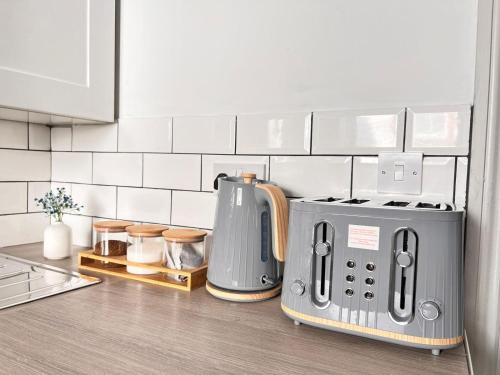a kitchen counter with a toaster and a coffee maker at Penrith in Penrith