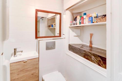 une salle de bain avec un lavabo et un miroir dans l'établissement Lovely Cosy Flat in Nice old town, à Nice