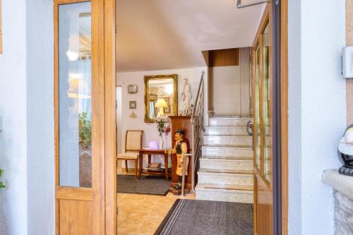 a child standing in the hallway of a home at Pansion Comfort Santa Marija in Novigrad Istria