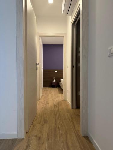 a hallway with white walls and wooden floors at LA ROSA DEL SILE in Quarto dʼAltino