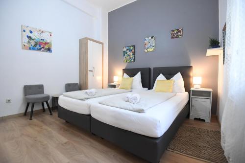 a bedroom with two beds and a table and a chair at Green lighthouse rooms in Zadar