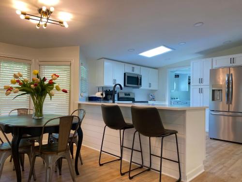 a kitchen with a table and chairs and a refrigerator at Whiskey Woods in Frankfort