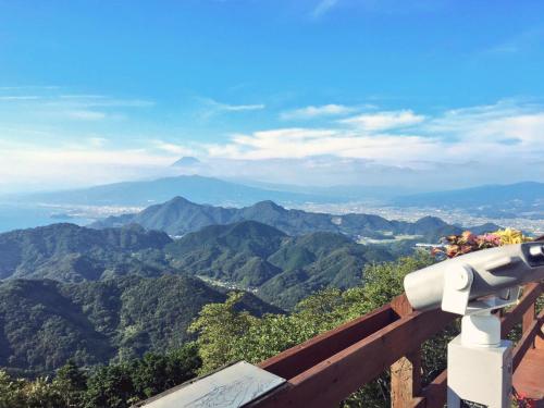 a view of a mountain range with a telescope at Ishinoya Izunagaoka - TKP Hotels & Resorts in Izunokuni