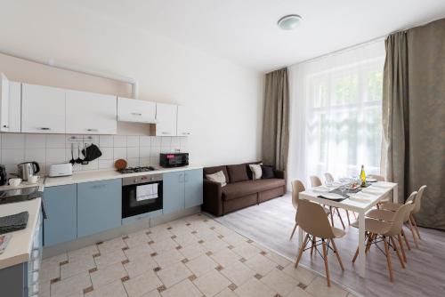 a kitchen and living room with a table and chairs at Prague - Karlin Apartments in Prague