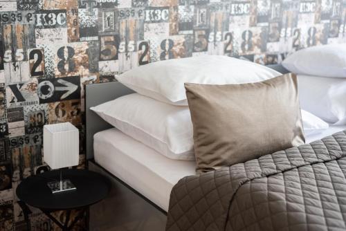 a bedroom with a bed with white sheets and pillows at Prague - Karlin Apartments in Prague