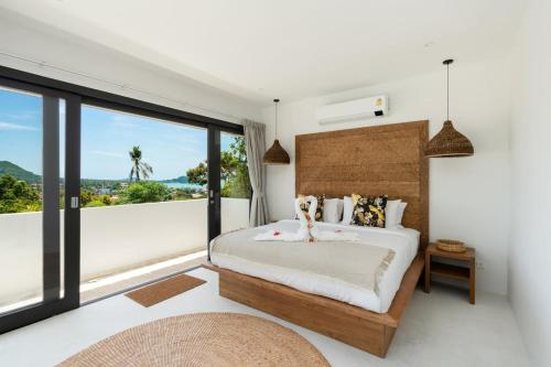 a bedroom with a bed and a large window at VIlla Tramonto sunset seaview villa Koh Samui in Koh Samui