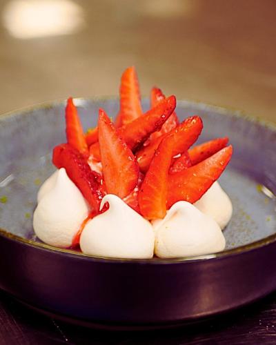 a pile of carrots on top of a bowl at Hôtel L'Ours De Mutzig in Mutzig