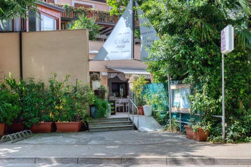 a building with stairs and plants in front of it at Pansion Comfort Santa Marija in Novigrad Istria