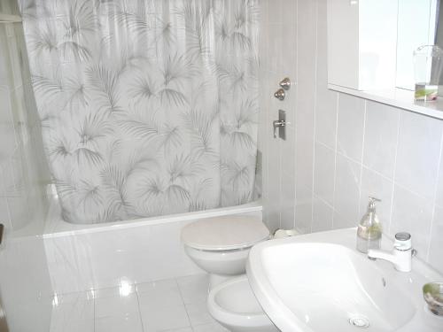 a bathroom with a toilet and a shower curtain at Studio with sea view furnished balcony and wifi at Marsala 1 km away from the beach in Marsala