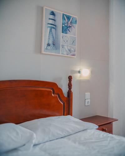 a bedroom with a bed and a lamp and a picture at Barraca Suites in Valencia