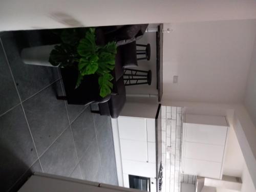 an overhead view of a staircase with a potted plant at Beautiful 5-Bed House in Dagenham newly Renovated in Dagenham