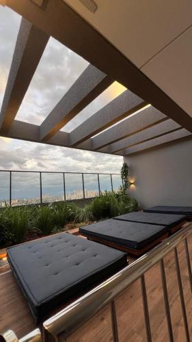 a balcony with two mattresses on a roof at Lindo flat em prédio luxuoso - Excelente localização in Goiânia