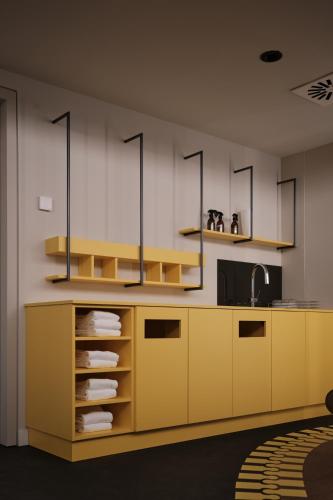 a kitchen with a yellow counter and a sink at The Zipper Hotel und Apartments in Düsseldorf