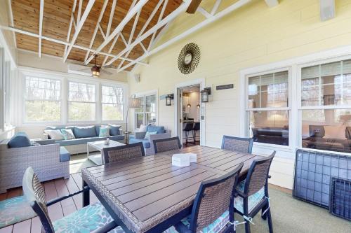 a porch with a wooden table and chairs at Rise n Shine in Saugatuck