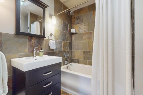 a bathroom with a sink and a bath tub at Rise n Shine in Saugatuck