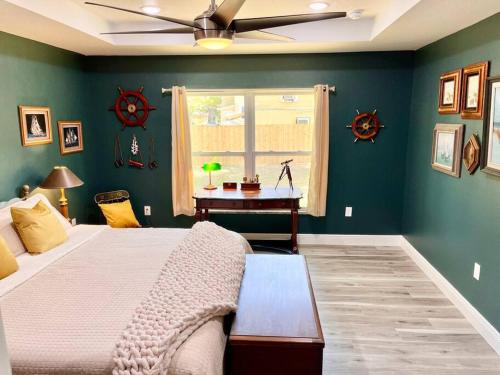 a bedroom with green walls and a bed with a table at Sanford's Seahaven in Sanford