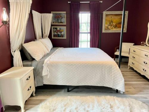 a bedroom with a large white bed and a window at Sanford's Seahaven in Sanford