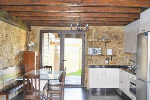 a kitchen with a table and a counter top at 4 bedrooms house with sea view enclosed garden and wifi at Cambados Pontevedra 1 km away from the beach in Cambados