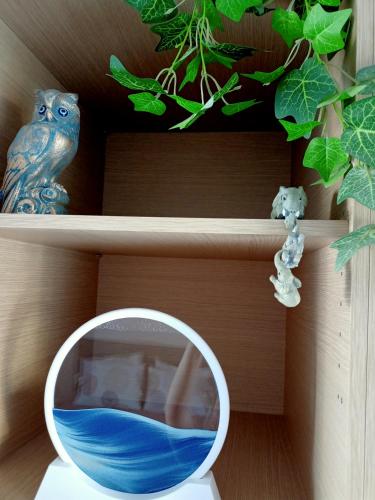 a mirror on a shelf next to a blue bowl at Myilios Leisure Piraeus by Ilios Company in Piraeus