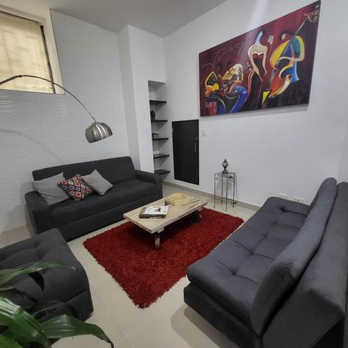 a living room with two couches and a coffee table at LA CASA DEL CABLE - Hermoso Apartamento - in Manizales