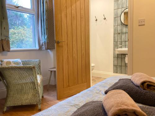 a bedroom with a bed and a wooden door at Laurel Bank House in Penrith