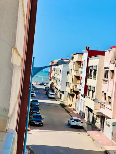 a view from a window of a street with parked cars at Appartement Vintage full équipé EL JADIDA in El Jadida