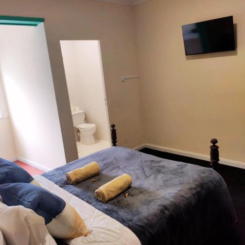 a bedroom with a bed with two pillows on it at Liberdade Home Royal direito in Braga