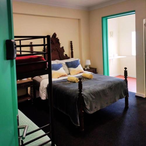 a bedroom with a bed with two bunk beds at Liberdade Home Royal direito in Braga