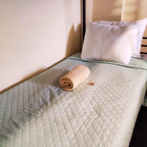 a towel sitting on a bed in a bedroom at Liberdade Home Royal direito in Braga